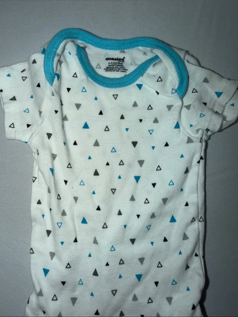 White Baby Onesie with Blue and Gray Triangle Print